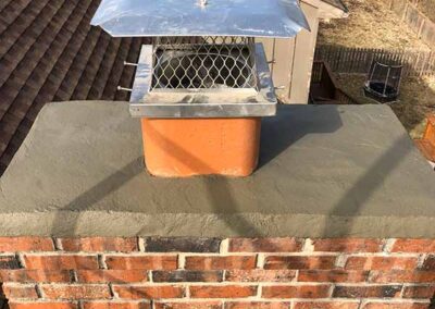 chimney cap and crown on a red brick chimney