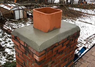 red brick chimney with a new crown