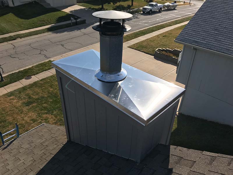 a grey chimney with a silver chase